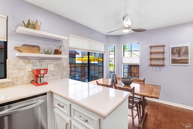 kitchen featuring dark wood-type flooring, dishwasher, ceiling fan, white cabinets, and kitchen peninsula