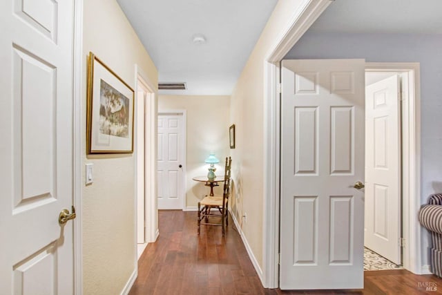 corridor with dark hardwood / wood-style floors