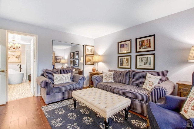 living room featuring hardwood / wood-style flooring and a notable chandelier