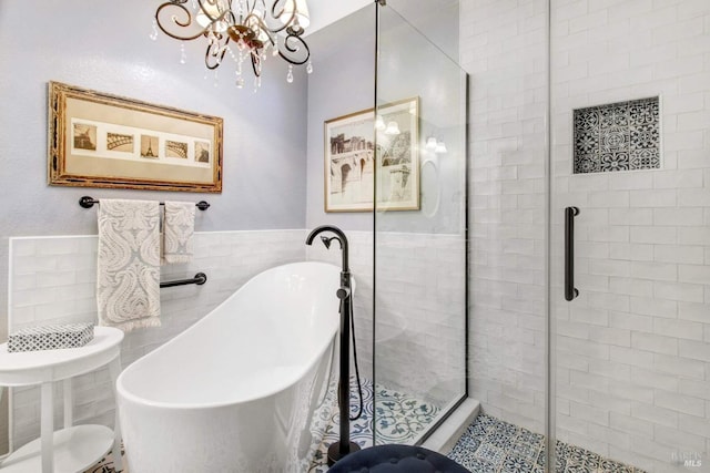 bathroom featuring tile walls and plus walk in shower