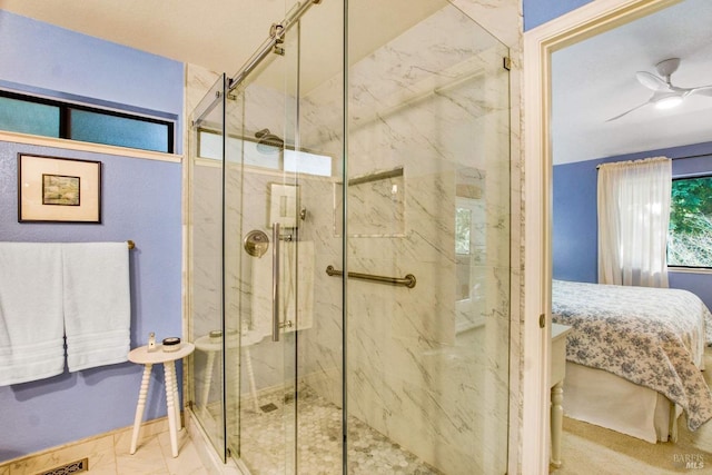 bathroom featuring a shower with door and ceiling fan