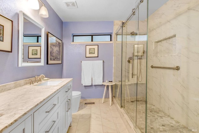 bathroom with vanity, toilet, and an enclosed shower