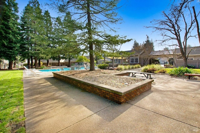 exterior space featuring a pool and a patio area