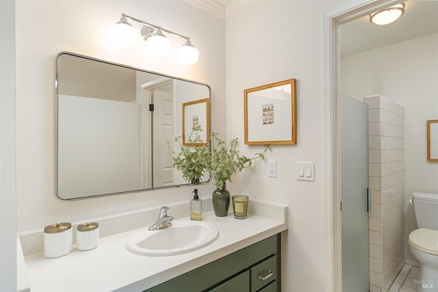 bathroom with toilet, crown molding, and vanity