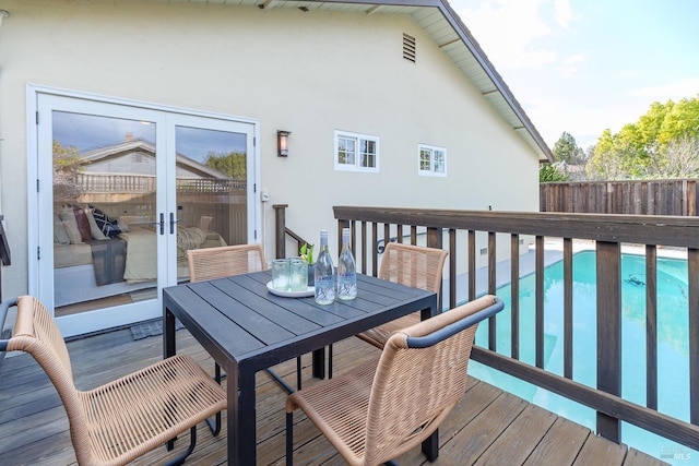 wooden deck with outdoor dining area and fence