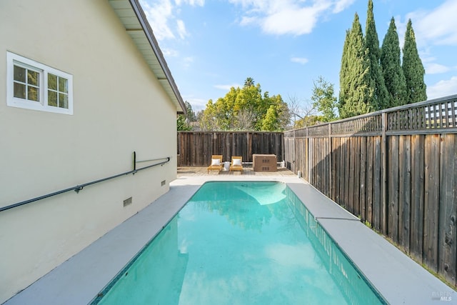 view of swimming pool with a patio area, a fenced backyard, and a fenced in pool