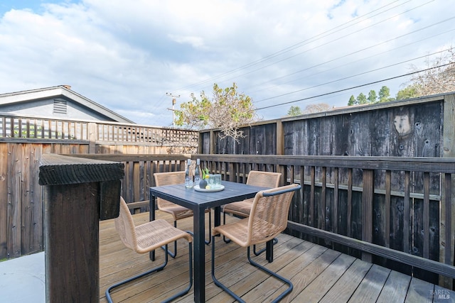 wooden deck featuring outdoor dining space