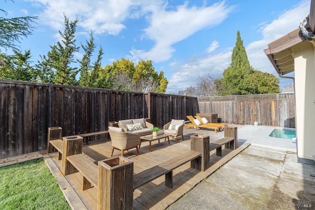 view of patio with a deck, outdoor lounge area, and a fenced backyard