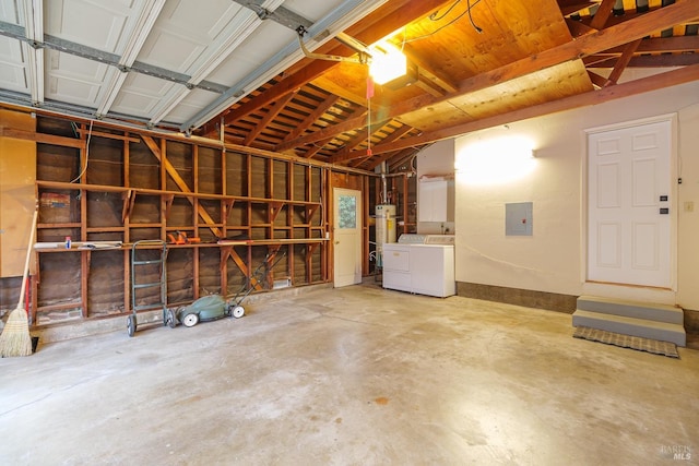 garage with washing machine and dryer and electric panel