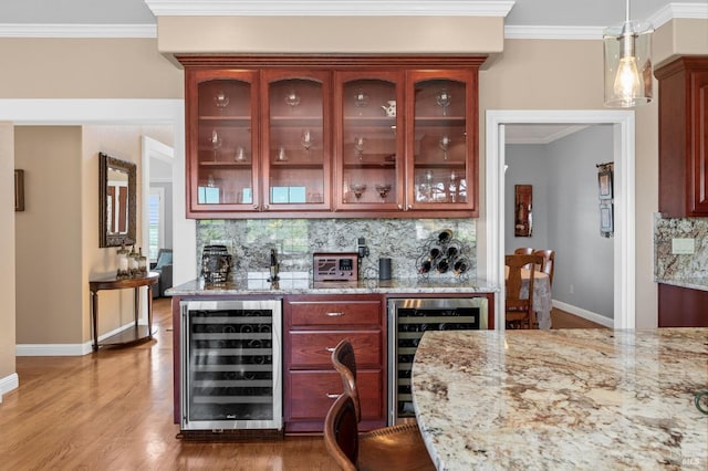 bar with light stone countertops, beverage cooler, decorative light fixtures, and decorative backsplash