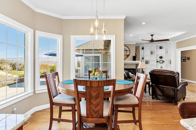 dining area featuring ornamental molding and light wood-type flooring