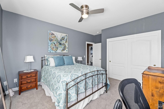 carpeted bedroom with a closet and ceiling fan