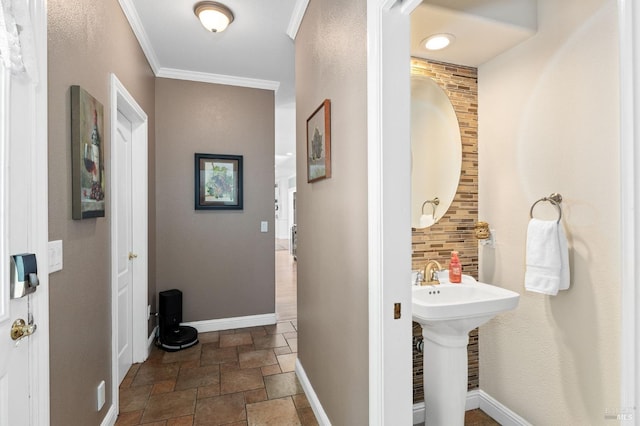 bathroom featuring crown molding, sink, and decorative backsplash