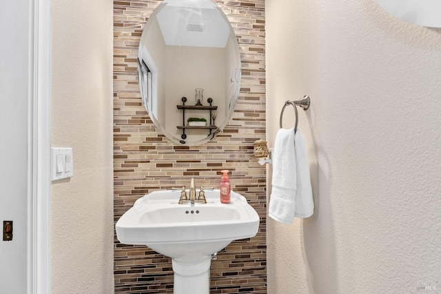 bathroom with tasteful backsplash