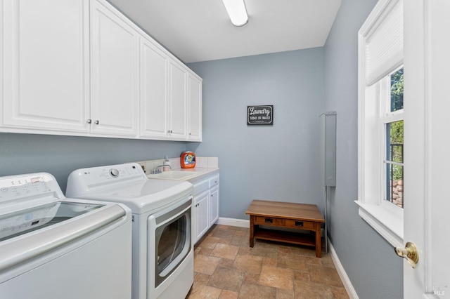 laundry room featuring sink, cabinets, and washing machine and clothes dryer