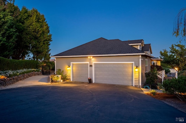 property exterior at dusk featuring a garage