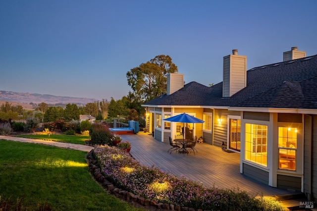 deck at dusk with a lawn