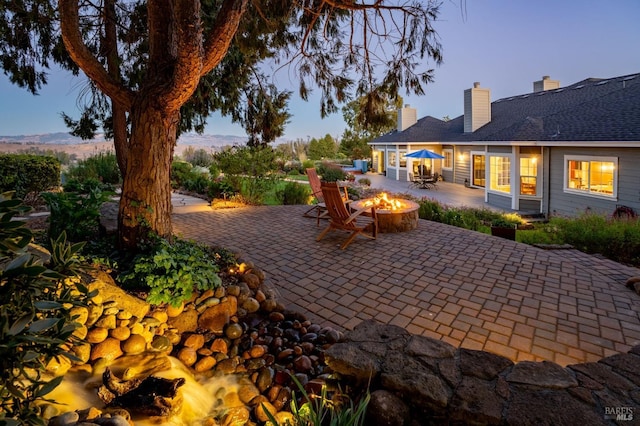 patio terrace at dusk with an outdoor fire pit