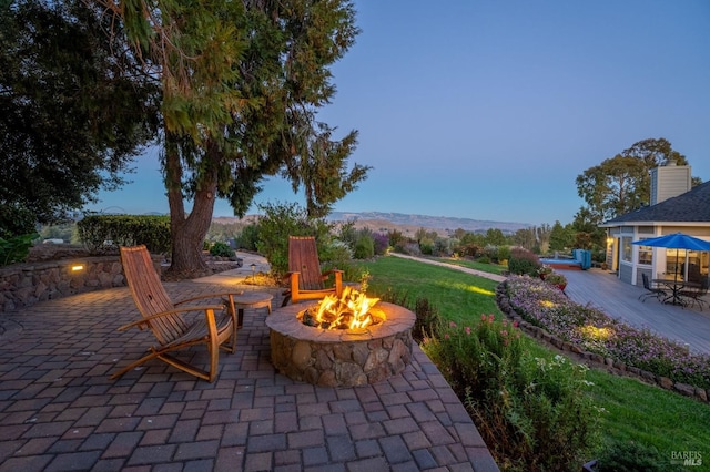 patio terrace at dusk with a fire pit