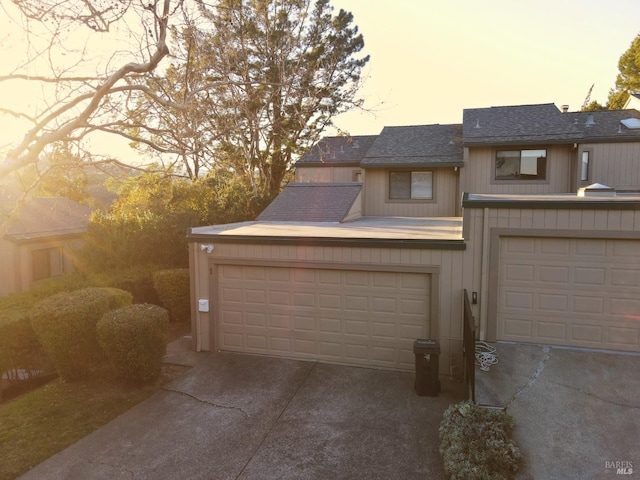 view of garage at dusk