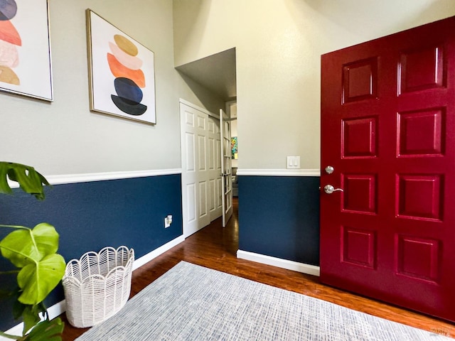 foyer with wood finished floors and baseboards