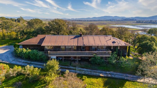 birds eye view of property with a water and mountain view