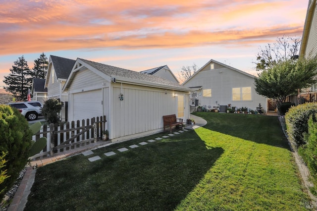 exterior space with a garage, a lawn, and an outdoor structure