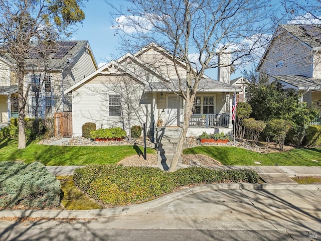 view of front of home featuring a front yard and covered porch