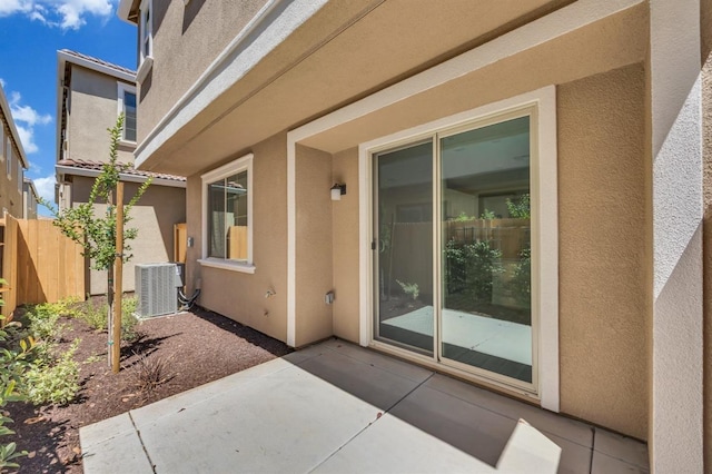 entrance to property with a patio and central air condition unit