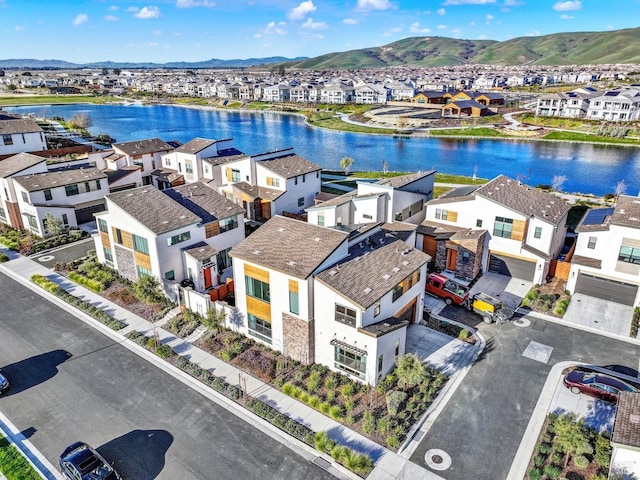 bird's eye view with a water and mountain view