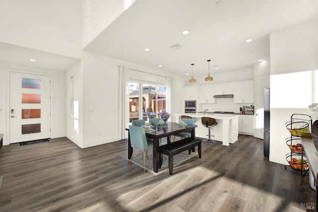 dining space featuring dark hardwood / wood-style flooring