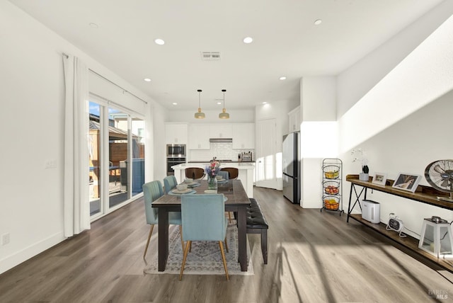 dining area featuring dark hardwood / wood-style floors