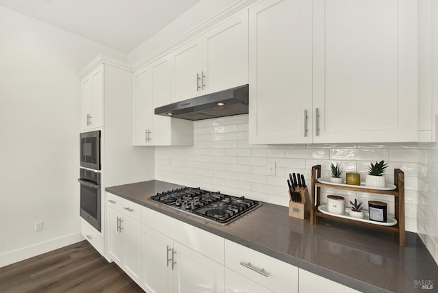 kitchen with stainless steel appliances, white cabinetry, dark hardwood / wood-style floors, and decorative backsplash