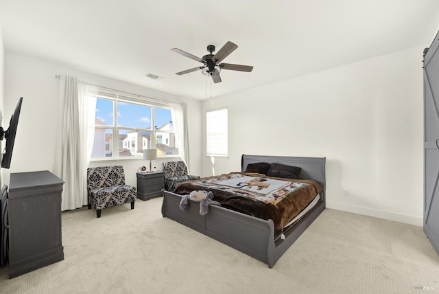 bedroom featuring ceiling fan and light carpet