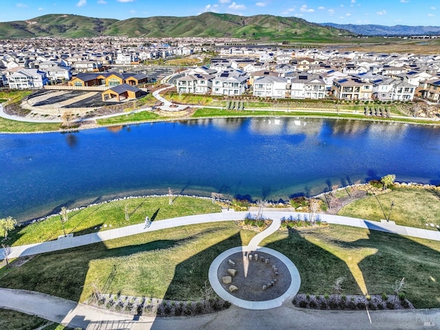 drone / aerial view with a water and mountain view