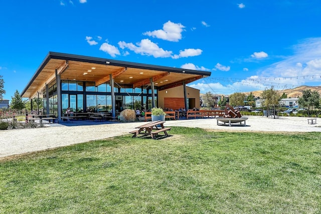 view of property's community with volleyball court and a lawn