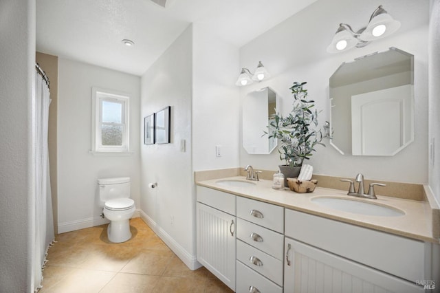 bathroom featuring vanity, tile patterned floors, and toilet