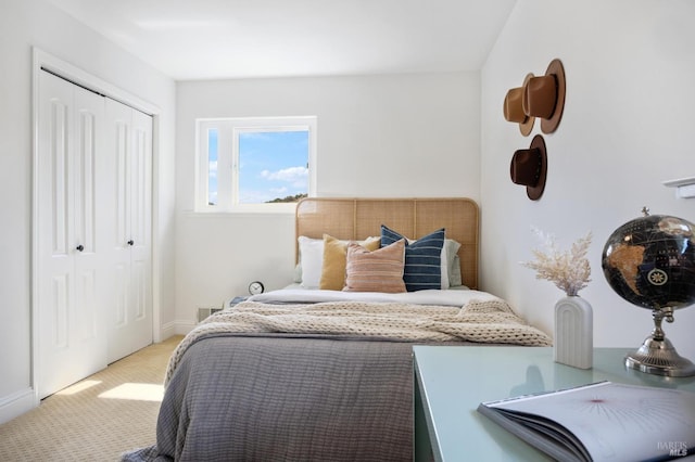 bedroom with light carpet and a closet