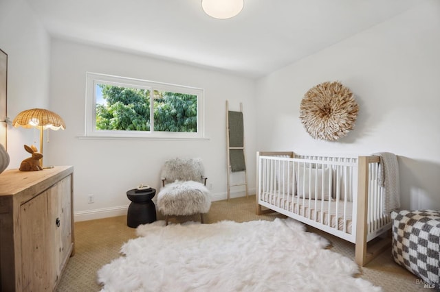 bedroom with a nursery area and light carpet