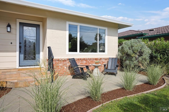 doorway to property with a patio