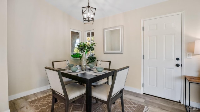 dining room with an inviting chandelier and light hardwood / wood-style flooring