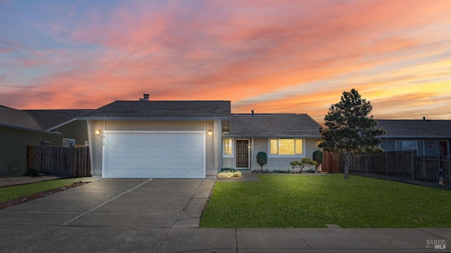 single story home with a yard and a garage