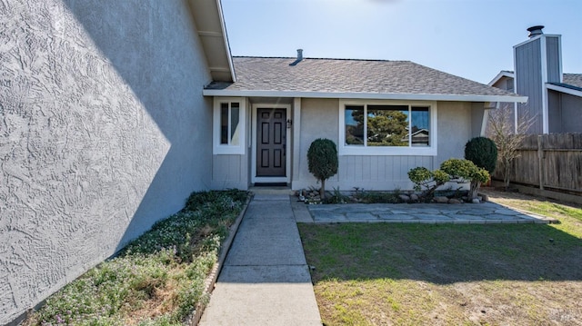 property entrance with a yard