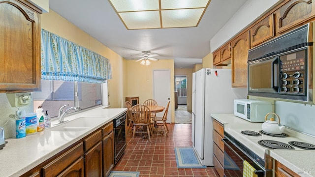 kitchen with sink, black appliances, and ceiling fan