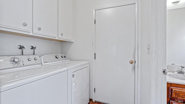 washroom featuring cabinets, separate washer and dryer, and sink