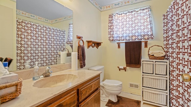 bathroom featuring vanity and toilet