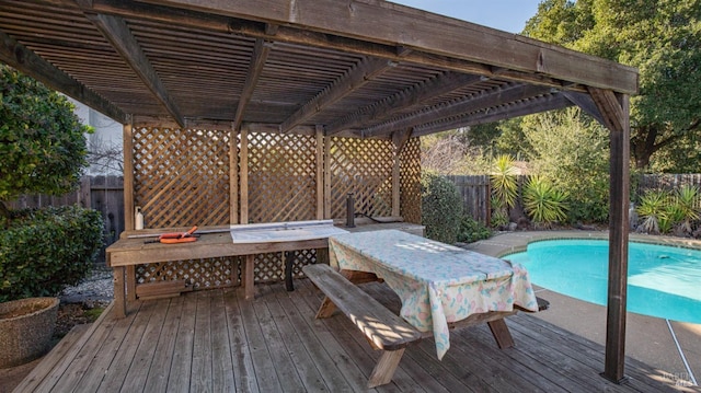 deck with a fenced in pool and a pergola