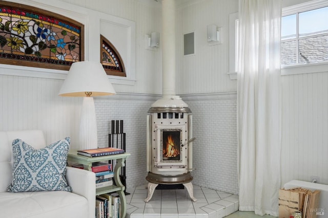 interior space featuring tile patterned floors and a wood stove