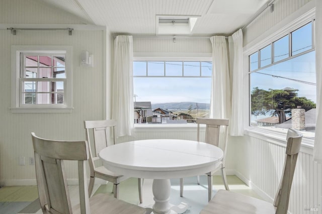 dining area with a healthy amount of sunlight and a mountain view