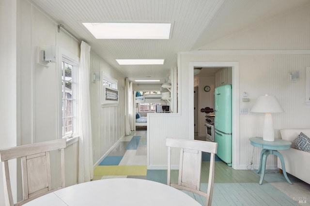 corridor featuring lofted ceiling with skylight